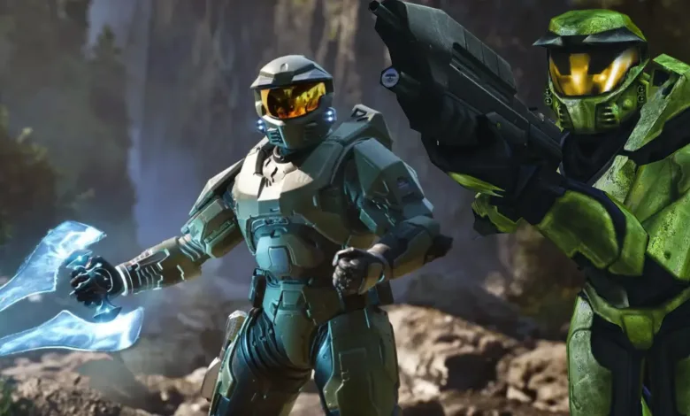 Two Spartan soldiers in green armor, one holding a plasma sword, the other a rifle.