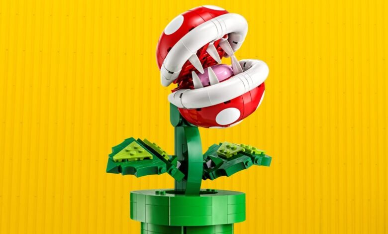 LEGO Piranha Plant model with open mouth and sharp teeth against a yellow background.