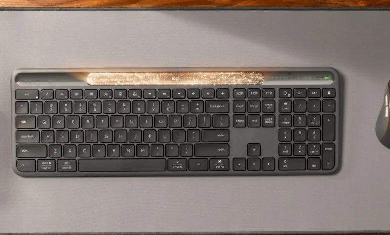 Logitech keyboard and mouse on a gray desk mat. The keyboard has a light strip with a sparkle effect.