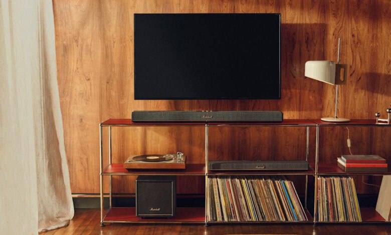 Marshall Woburn II soundbar and subwoofer in a mid-century modern living room with vinyl records and a TV.