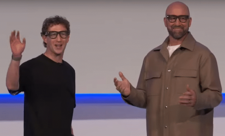 Mark Zuckerberg and Mark Shuttleworth on stage, waving and gesturing.