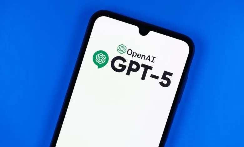 Smartphone displaying the OpenAI GPT-5 logo on a bright white screen against a vibrant blue background.
