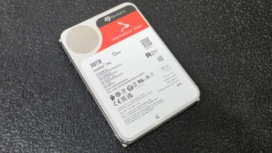 Seagate IronWolf Pro 30TB hard drive on a dark surface. The label shows specifications and certifications.