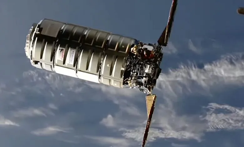 SpaceX Dragon cargo spacecraft approaching the International Space Station, against a backdrop of Earth's atmosphere.