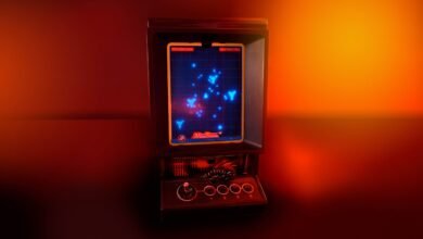 Retro Vectrex video game console with Mine Storm game displayed on screen, lit with warm red and orange lighting.