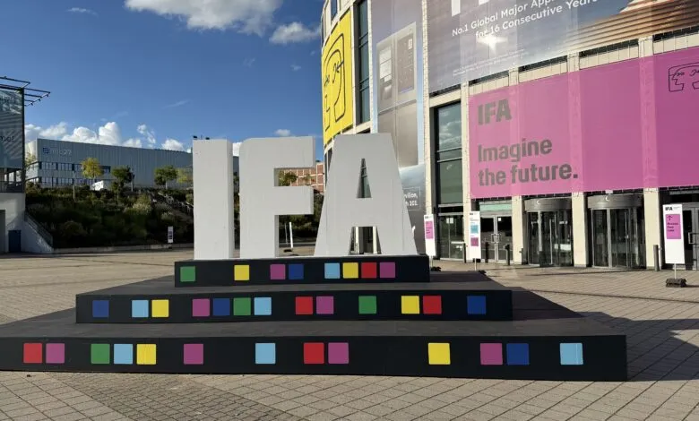 Large white IFA letters on a tiered platform decorated with colorful squares.
