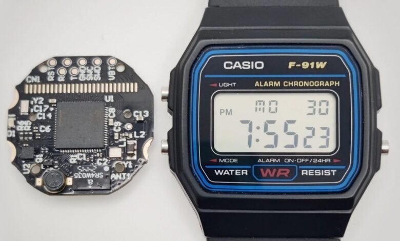 Close-up of a Casio F-91W digital watch next to a small circuit board.
