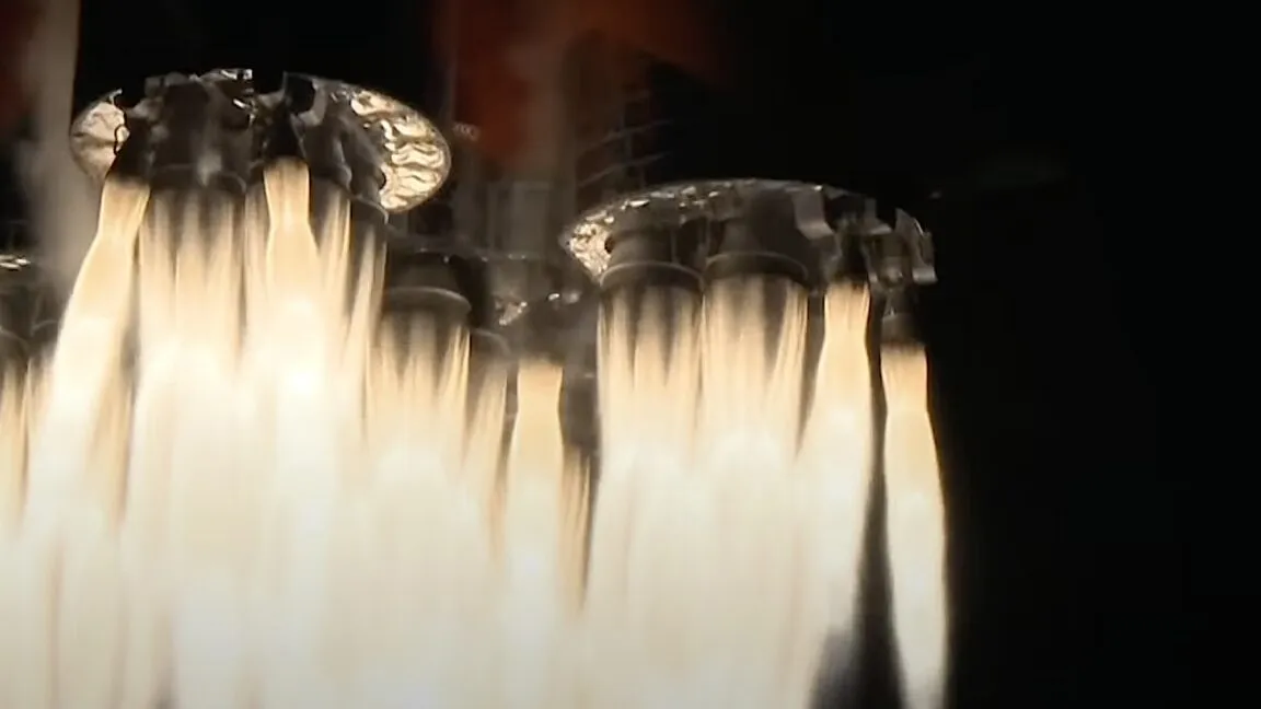 Close-up of rocket engine ignition, powerful flames and exhaust billowing.