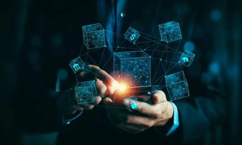 Person interacts with a phone displaying a network of glowing blue data cubes, representing blockchain technology in finance.