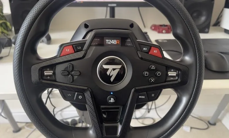 Close-up of a Thrustmaster T248 racing wheel, showcasing its buttons, controls, and PlayStation compatibility.