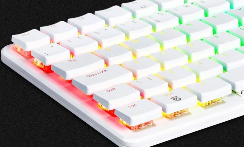 Close-up of a white mechanical keyboard with RGB backlighting, showing keys like Ctrl, Shift, and Caps Lock.