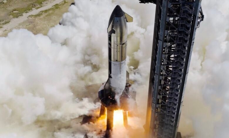 SpaceX Starship rocket ignites engines and lifts off, surrounded by smoke and flames.