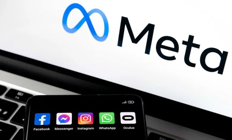 Meta logo displayed on a laptop screen, with a phone showing Facebook, Messenger, Instagram, WhatsApp, and Oculus apps.