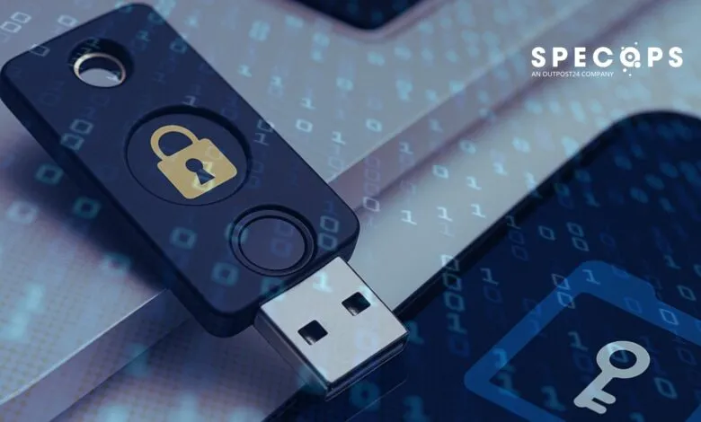 Close-up of a USB security key with a lock icon, overlaid on a digital background of binary code.