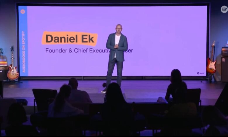 Daniel Ek, Founder & CEO of Spotify, presents on stage with a purple background.