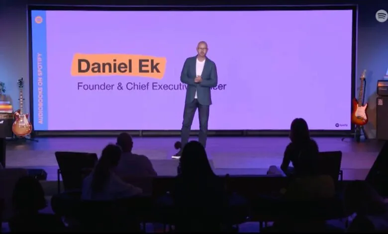 Daniel Ek, Founder & CEO of Spotify, presents on stage with a purple background.