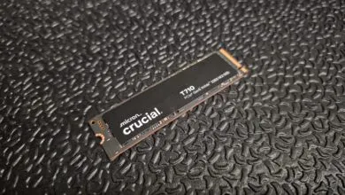 Close-up of a Crucial T710 PCIe Gen5 NVMe 2280 M2 SSD on a textured black surface.