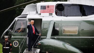 Donald Trump, former US President, exits a Marine One helicopter, giving a thumbs-up.