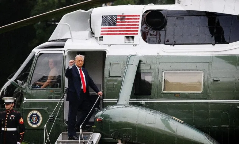 Donald Trump, former US President, exits a Marine One helicopter, giving a thumbs-up.