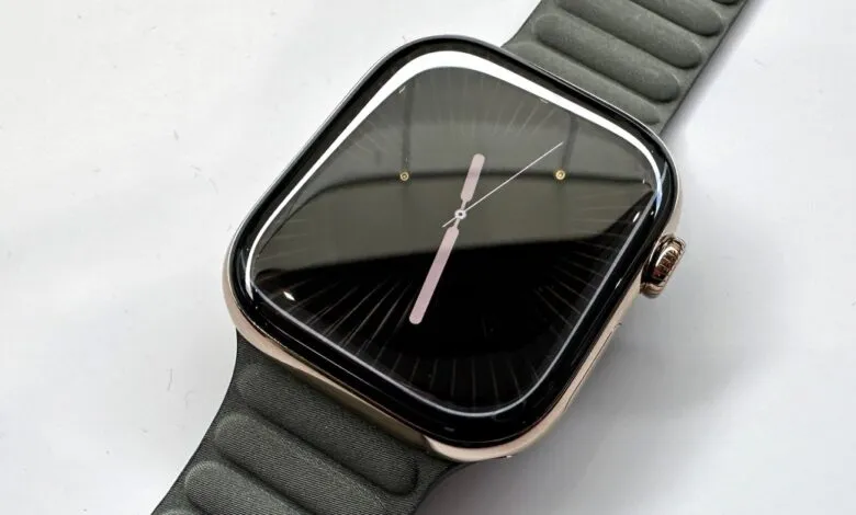 Apple Watch Ultra with dark watch face and olive green sport band.