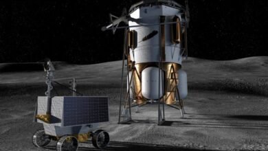 A lunar lander and rover on the moon's surface under a starry sky.