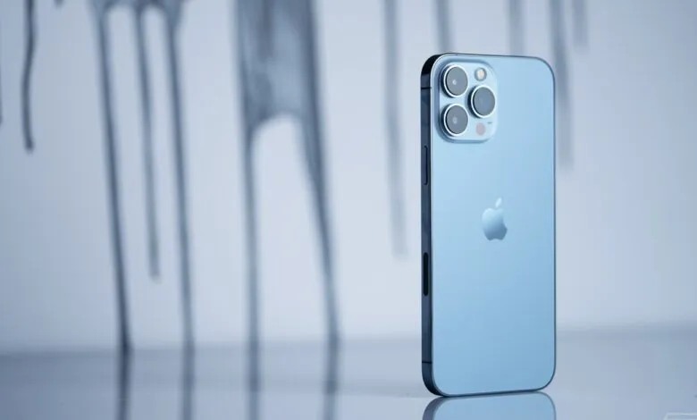 Close-up of a light blue iPhone 12 Pro Max, showcasing its sleek design and triple-lens camera.