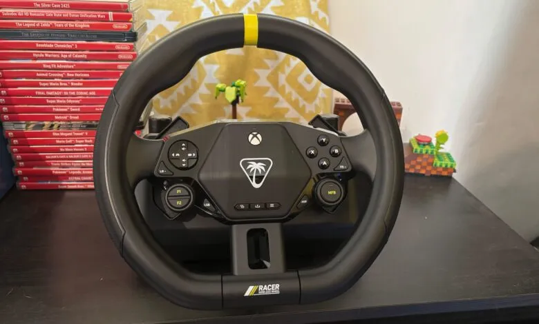 Black racing wheel with yellow accent, featuring Xbox controller buttons and a palm tree logo.