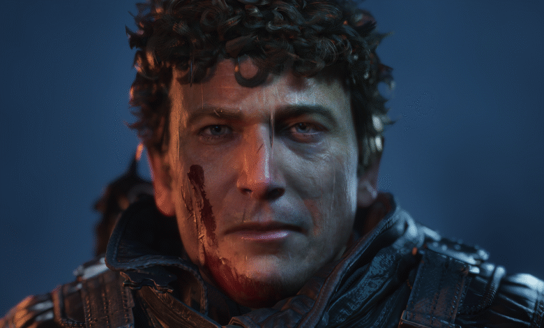 Close-up portrait of a man with curly hair and bloodstains on his face, set against a dark blue background.