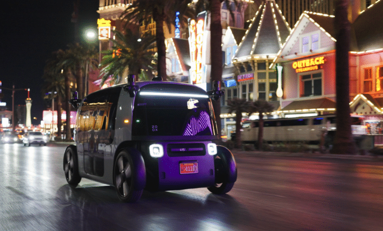 Self-driving Zoox vehicle navigating Las Vegas Strip at night.