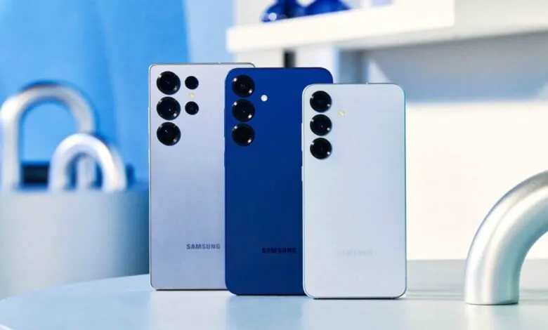 Three Samsung Galaxy smartphones in different colors arranged on a table.