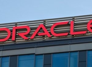 Close-up of the red Oracle logo on the side of a modern building.