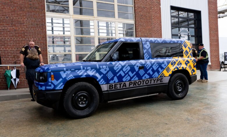 A blue pickup truck with a custom graphic wrap labeled 'BETA PROTOTYPE'.