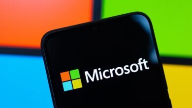 Close-up of a smartphone displaying the Microsoft logo and name.