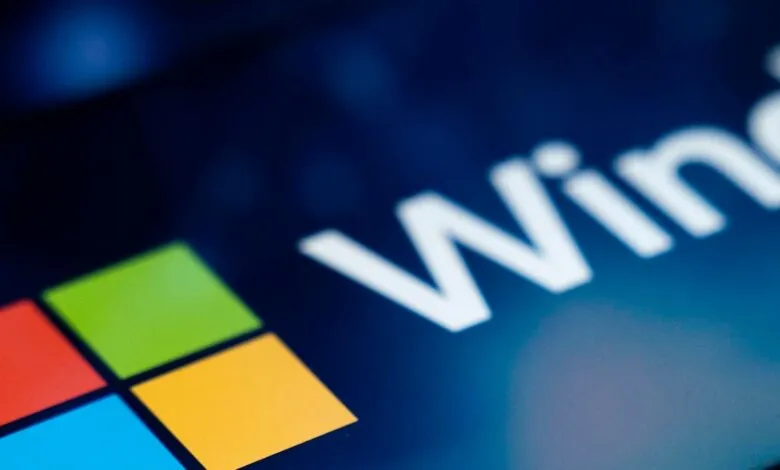 Close-up of the Microsoft Windows logo with its four colored squares and the word 'Windows' in white.