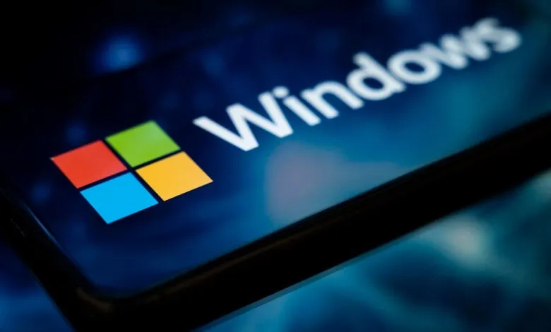 Close-up of the Windows logo and text on a dark blue, glowing screen.