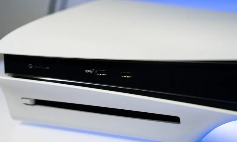 Close-up of the front ports and power button on a white PlayStation 5 Slim console.