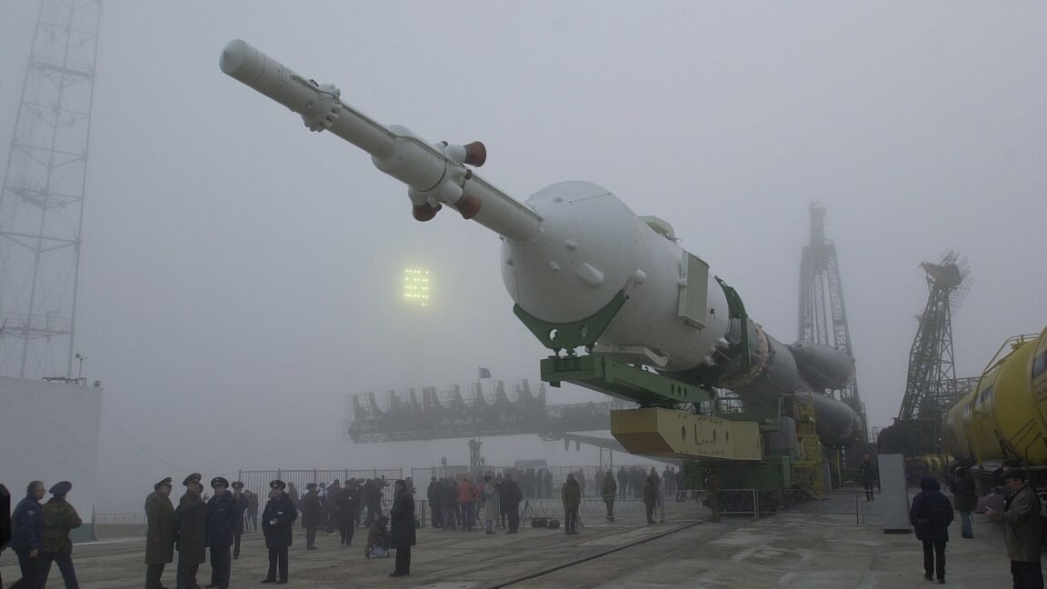 Soyuz rocket being transported to the launch pad on a foggy day at Baikonur Cosmodrome.