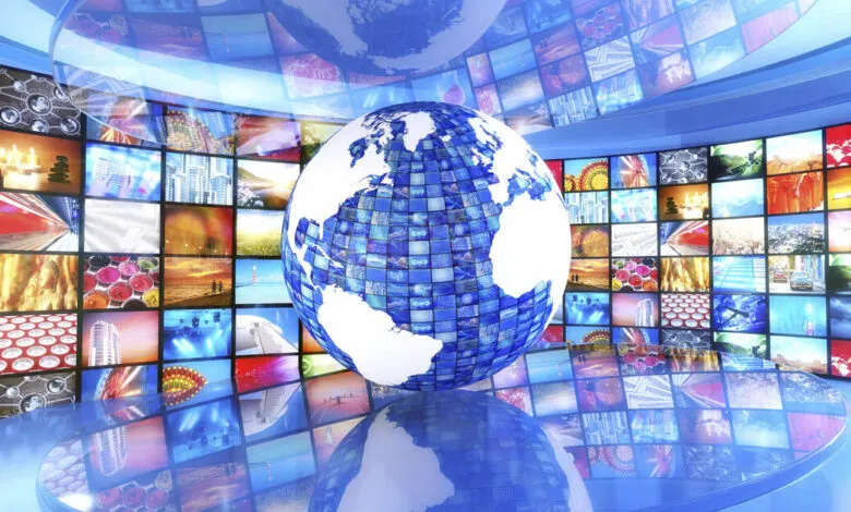 A digital globe made of screens displays various images, surrounded by a wall of screens.