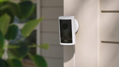 Ring security camera mounted on a light-colored exterior wall.