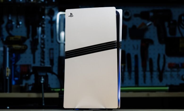 White PlayStation 5 console with black accents, standing upright in a workshop.