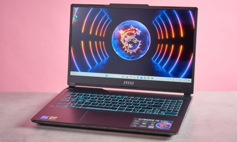 An open MSI gaming laptop with a dragon logo wallpaper and illuminated keyboard.