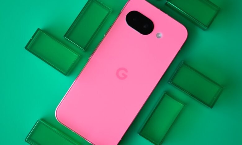 Pink Google Pixel phone with a camera bump surrounded by green rectangular objects.