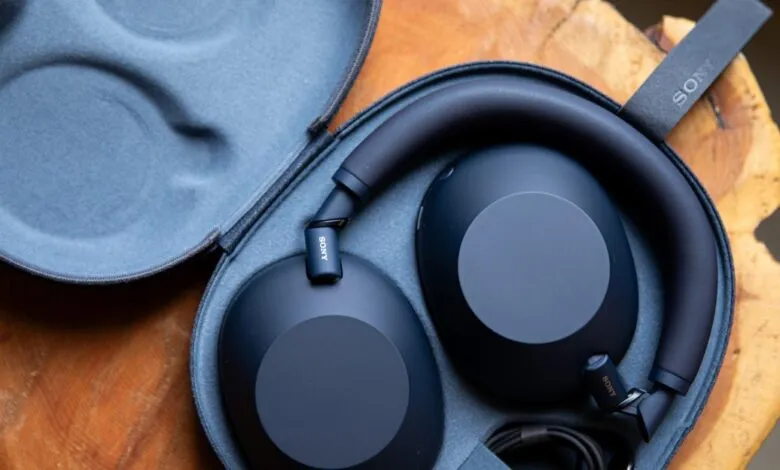 Dark blue Sony WH-1000XM6 headphones in their protective case.