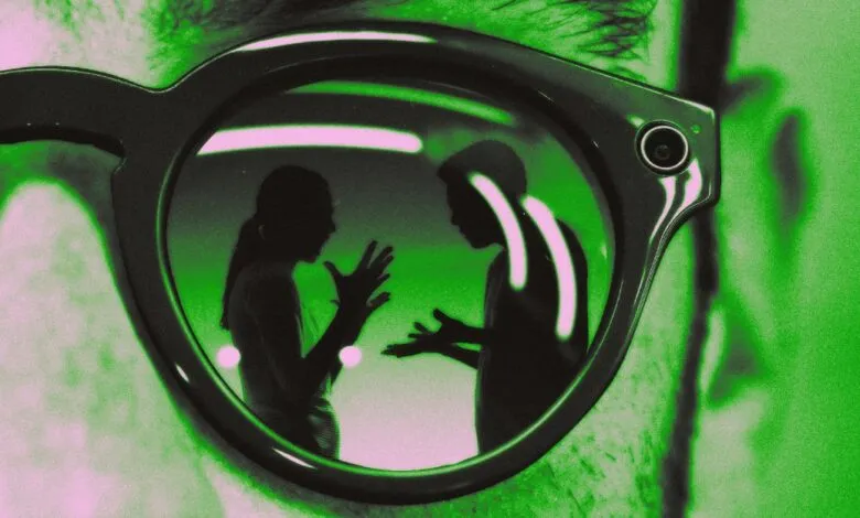 Close-up of smart glasses reflecting two people in silhouette talking.