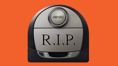 A Neato robot vacuum cleaner with 'R.I.P.' engraved on its surface.