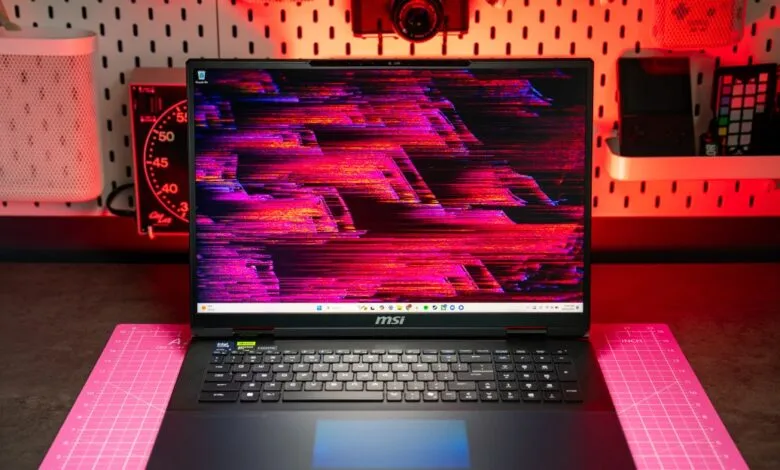 MSI Titan 18 gaming laptop with a vibrant, glitchy abstract wallpaper displayed.