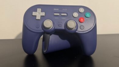 A dark purple 8BitDo Pro 3 controller with gray directional buttons and joysticks.