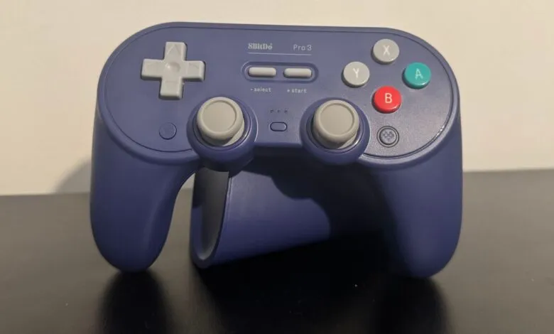 A dark purple 8BitDo Pro 3 controller with gray directional buttons and joysticks.