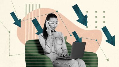 Woman on phone looking shocked with laptop, surrounded by downward trending arrows.