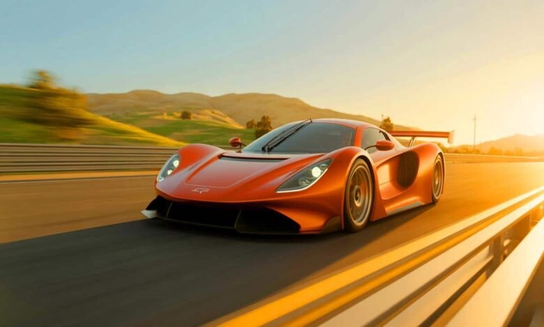 Orange hypercar speeding on a race track at sunset.